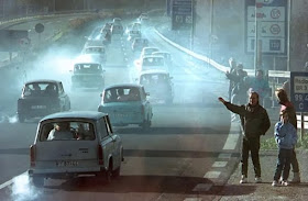 East Germans drive their oil-belching Trabants west, which even today seems better than being dead in a Tesla.